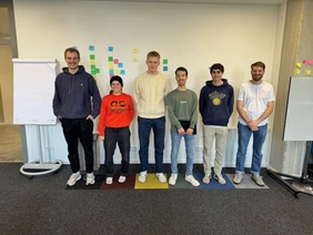 Studierende im Fokus: Der Scale-up-Raum lädt zu kreativem und eigenständigem Arbeiten ein (Foto: THI). Studierende mit unterschiedlichen Körpergrößen stehen auf farblich unterschiedlichen Teppichelementen