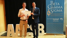 Two men are presenting a certificate.